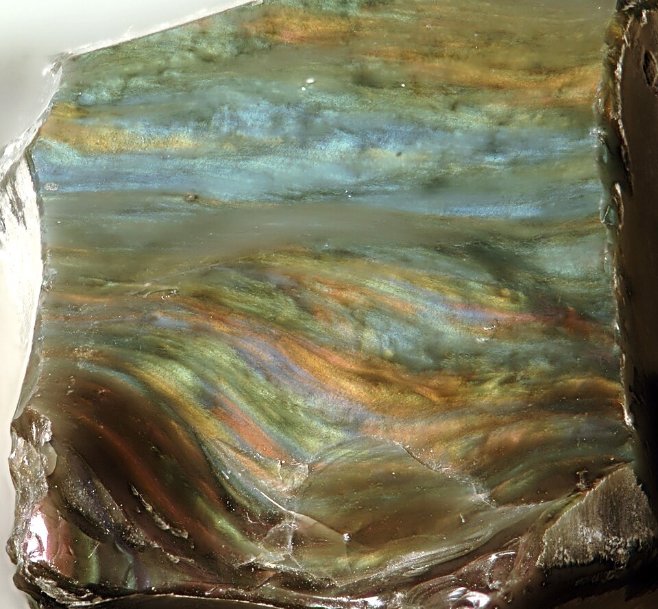 Rainbow Obsidian specimen Rainbow Obsidian specimen: black with rainbow sheen and purple igneous rock